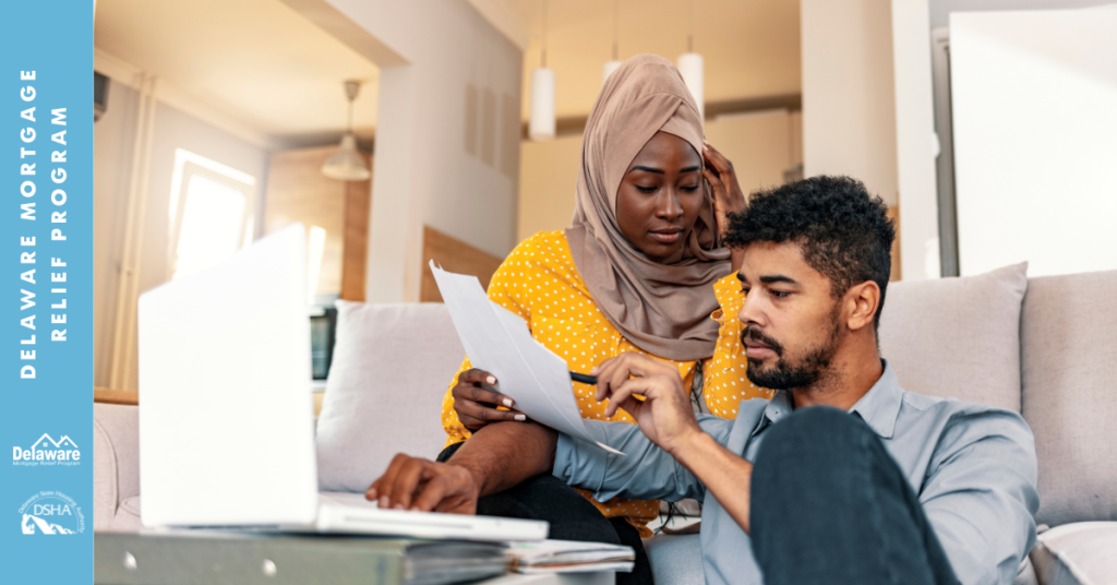 A graphic of a man and woman looking at paperwork.