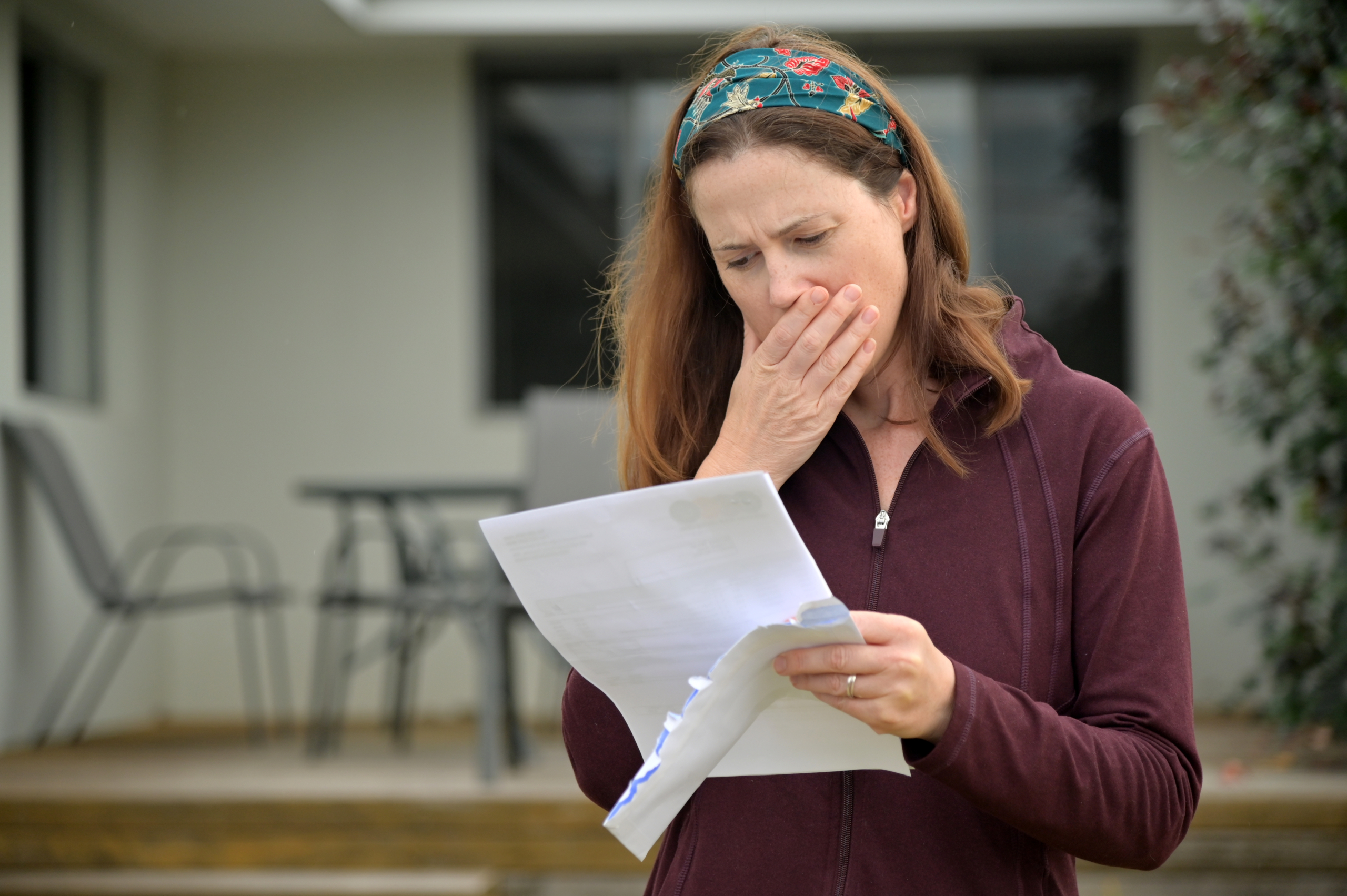 Upset woman reading an eviction notice letter