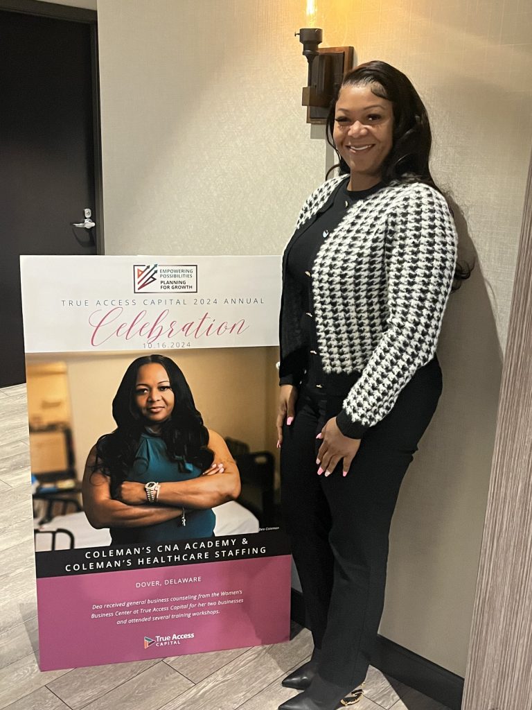 Dea Coleman standing next to a sign highlighting her nursing assistant classes.