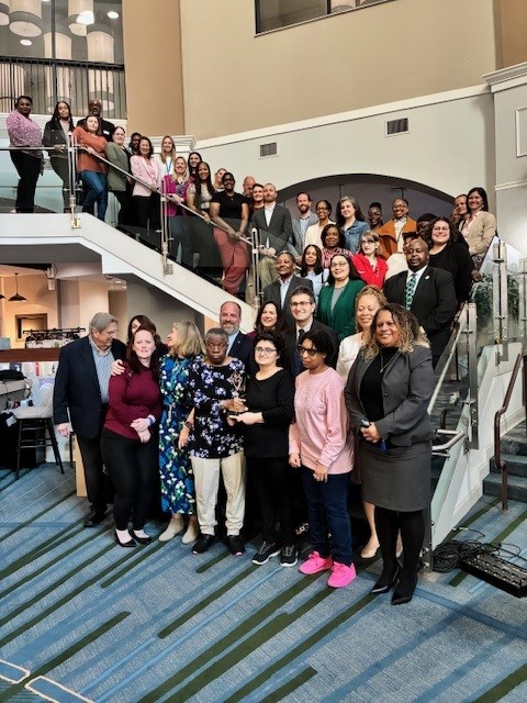 Members and partners of the Delaware Interagency Collaborative to End Homelessness gathered for a group photo on a staircase
