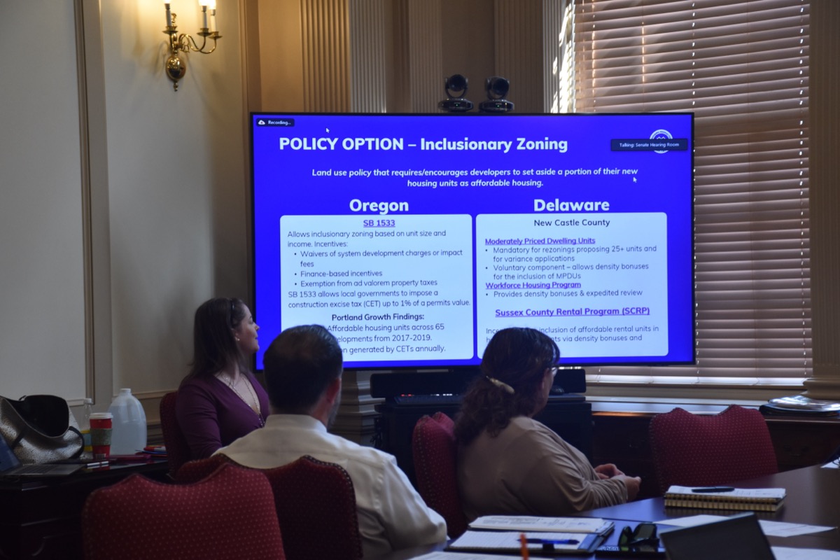 Task Force members reviewing an inclusionary zoning policy presentation during a meeting