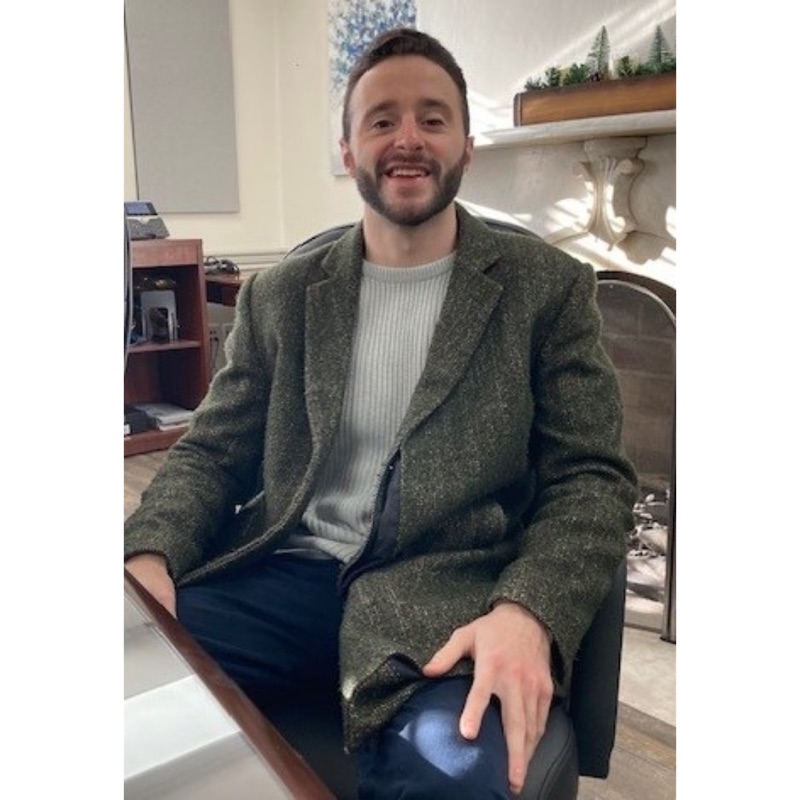 Alex Modeas seated at a desk in DSHA’s offices